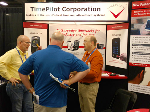 TimePilot makes a splash at the Fastenal show: CEO Doug Marsh (left) answers questions about TimePilot systems from attendees at the Fastenal Customer Industrial & Construction Expo last month in Nashville.